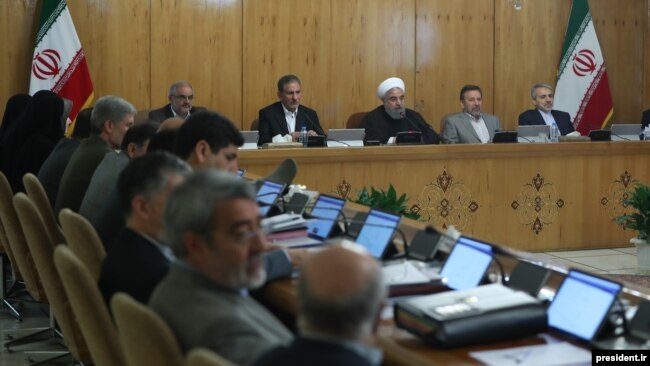 A handout picture provided by the office of Iranian President Hassan Rouhani on September 13, 2017 shows him (3nd R) sitting next to Vice President Eshaq Jahangiri (2nd L) during a cabinet meeting in Tehran.