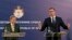 Serbian President Aleksandar Vucic (right) speaks at a press conference after talks with EU Enlargement Commissioner Johannes Hahn (left) in Belgrade on February 7.