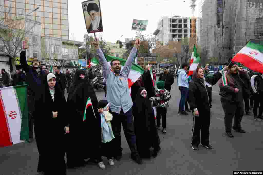 Protesters gather with Iranian national flags during a demonstration in support of the government and against US and Israeli strikes in Tehran.