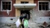 Residents carry their belongings from their damaged homes after a cease-fire began during the fighting over the breakaway region of Nagorno-Karabakh in the city of Terter, Azerbaijan.