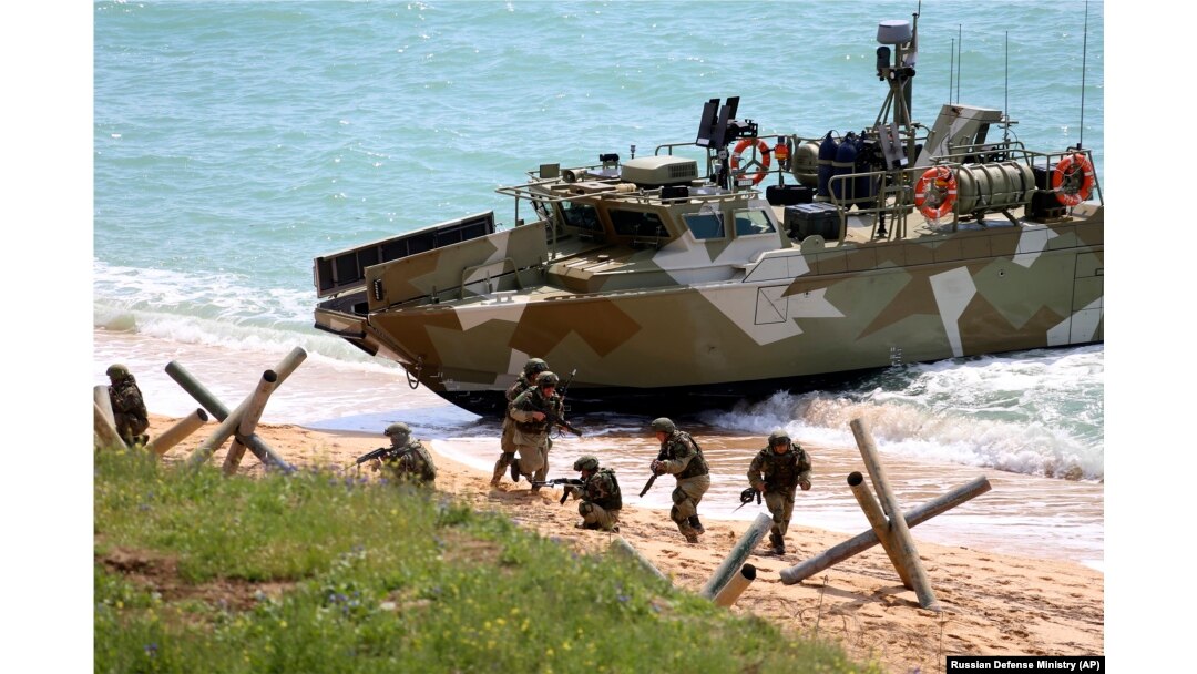 Russian troops disembark from a landing boat during drills in Crimea.