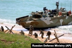 Russian troops disembark from a landing boat during drills in Crimea.