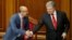 Ukrainian President Petro Poroshenko (right) shakes hands with parliament speaker Andriy Parubiy after voting on a law to establish an anticorruption court during a parliament session in Kyiv on June 7.