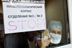 A medical staff member peers out of the pulmonary department of a Vladivostok hospital.