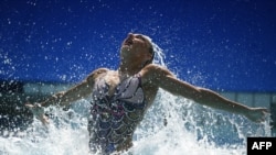 Natalia Ishchenko and Svetlana Romashina won synchronized swimming duets gold, maintaining a 26-year Russian winning streak.