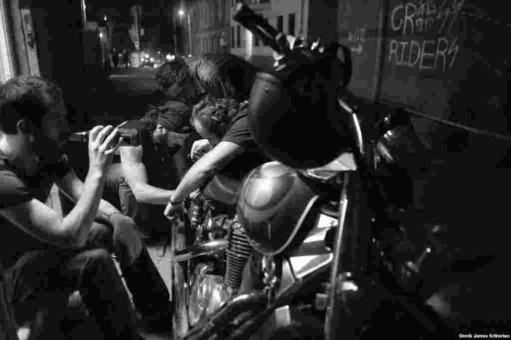 A Cross Riders MC member repairs one of their motorbikes.&nbsp;