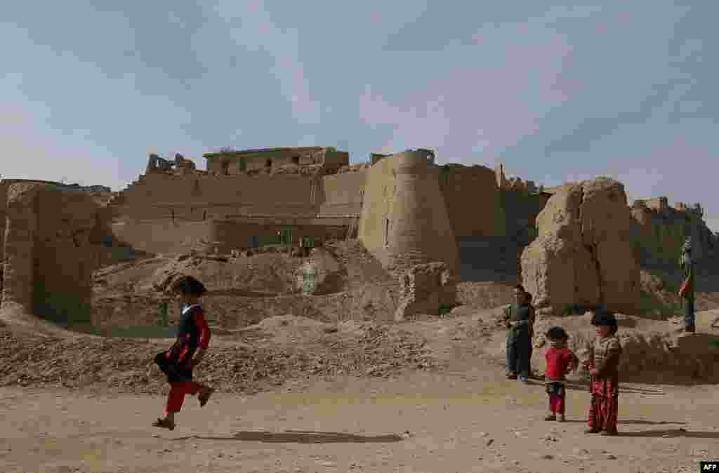 Afghan girls play at an ancient place in Ghazni on November 22. Poverty and an ongoing insurgency by the ousted Taliban still pose a threat to the stability of the country. (AFP/Rahmatullah Alizada)