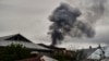 Smoke rises behind houses after shelling in Nagorno-Karabakh. The recent escalation in hostilities in the breakway region has also seen a surge in tweets about the conflict. 