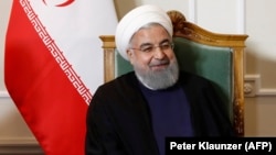 Iranian President Hassan Rohani poses for a picture at the beginning of a meeting during his official visit to Bern on July 2.