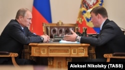Russian President Vladimir Putin (left) appointed Andrei Turchak (right) as the governor of the Altai Republic, which is seen as a demotion by observers. (file photo)