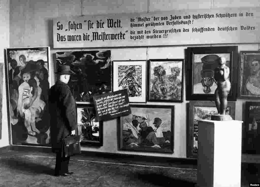 A man looks at pieces from the Nazi-curated travelling exhibition, &quot;Degenerate Art&quot; (&quot;Entartete Kunst&quot;), which was displayed at the Haus der Kunst in Berlin on February 24, 1938.