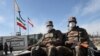 FILE: Pakistani soldiers wearing face masks patrol near the closed Pakistan-Iran border in Taftan in late February.