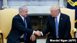U.S. President Donald Trump shakes hands with Israel's Prime Minister Benjamin Netanyahu in the Oval Office of the White House in Washington, March 5, 2018