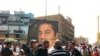 Protesters on Baghdad’s Freedom Square rally against corruption and the poor state of public utilities while carrying photos of Iraqi civil activist Hadi al-Mehdi, who had co-organized a number of regular Friday antigovernment protests until he was murder