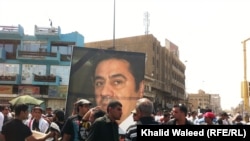 Protesters on Baghdad’s Freedom Square rally against corruption and the poor state of public utilities while carrying photos of Iraqi civil activist Hadi al-Mehdi, who had co-organized a number of regular Friday antigovernment protests until he was murder