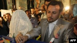 A bride and groom cast their votes in Iran's presidential election last June.