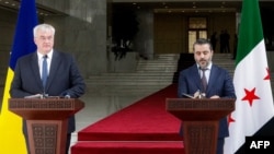 Asaad Shaybani (right), foreign minister for the interim Syrian government, and Ukrainian Foreign Minister Andriy Sybiha give a joint press conference in Damascus on December 30.