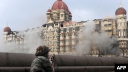 An Indian soldier aims his weapon toward the Taj Mahal Hotel during the military operation against militants in Mumbai.