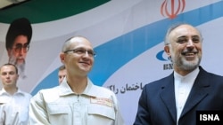 Russia's nuclear agency chief Sergei Kiriyenko (left) meets with his Iranian counterpart, Ali Akbar Salehi, before the launch of the Bushehr plant.