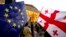 Demonstrators gather with Georgian national and EU flags during a pro-EU and anti-government rally in front of the parliament in Tbilisi on July 3.