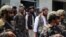 Anas Haqqani (center), the youngest son of Taliban co-founder Jalaluddin Haqqani, is escorted by Taliban fighters as he visits Hamid Karzai International Airport after the U.S. withdrawal in Kabul on August 31.