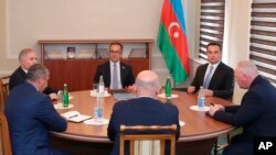 Representatives of the ethnic Armenian community of Nagorno-Karabakh, Azerbaijan's government, and a representative of the Russian peacekeeping contingent attend talks in the Azerbaijani city of Yevlax on September 21.