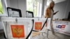 A member of a local electoral commission in central Moscow inspects a polling station ahead of elections to the Russian State Duma. The three-day election is the first nationwide vote since 2024, when Vladimir Putin won a fifth presidential term, and the first parliamentary vote since the start of the all-out war on Ukraine in 2022.