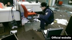 Police inspect the damaged Alfa Bank in Kyiv after the attack.