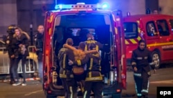 Wounded people are evacuated from the Stade de France in Paris after explosions were reported. 