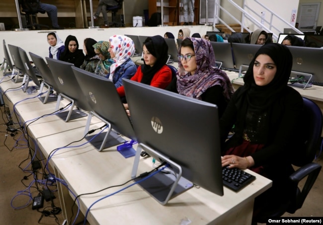 Afghan election workers wait for vote-count papers at the database center of the Afghanistan Independent Election Commission in Kabul on October 24.