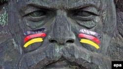 Germany -- Black, red and golden stripes adorn the face of the Karl Marx statue at the Marx Monument in Chemnitz, June 6, 2014