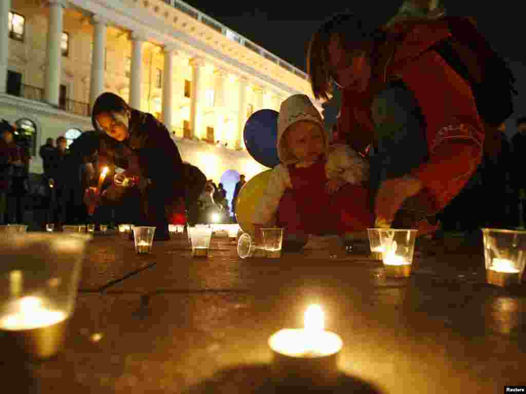 People light candles during a flashmob to mark the Day of Ukrainian Language in Kyiv on November 9. Photo by Konstantin Chernichkin for Reuters