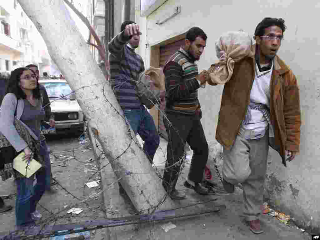 Antigovernment protesters prepare sacks of stones for use on the square.