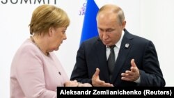 Russian President Vladimir Putin (left) and German Chancellor Angela Merkel in Osaka, Japan, in June