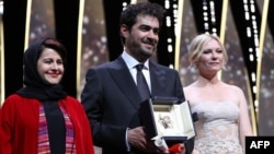 Iranian actor Shahab Hosseini (center) poses with Cannes jury members Iranian producer Katayoon Shahabi (left) and American actress Kirsten Dunst after being gvien the Best Actor prize during the closing ceremony of the 69th Cannes Film Festival. 