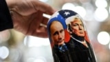 A vendor shows a traditional Russian wooden nesting doll depicting Vladimir Putin and Donald Trump at a gift shop in central Moscow. (file photo)