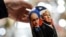 A vendor shows a traditional Russian wooden nesting doll depicting Vladimir Putin and Donald Trump at a gift shop in central Moscow. (file photo)