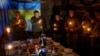 Ukrainian soldiers pray before a Christmas dinner in the Donetsk region on December 24. 