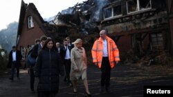 Міністр внутрішніх справ Німеччини Ненсі Фезер (по центру) приїхала на місце, де згорів будинок для українських біженців