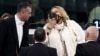 Diana Iovanovici-Sosoaca (center) wears a muzzle surrounded by bailiffs as she is escorted out of the European Parliament in Strasbourg on July 18.
