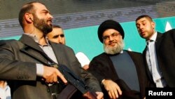 Hizballah leader Sayyed Hassan Nasrallah (second from right) in Beirut in 2012. Among other things, the State Department report said that "terrorist groups supported by Iran -- most prominently Hizballah -- continued to threaten U.S. allies and interests." (file photo) 