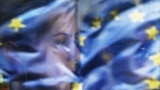 Serbia - A Serb woman peers through a tram window as more than 1,000 supporters of the pro-Western Liberal Democratic Party waves EU flags, 9May2008.