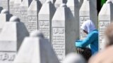 BOSNIA-HERZEGOVINA -- Bosnian Muslim woman, survivor of Srebrenica 1995 massacre, prays near graves of her relatives, at the memorial cemetery in Potocari, near Eastern-Bosnian town of Srebrenica, on July 11, 2019.