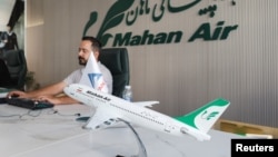 An employee works at the office of Iran's Mahan Air in Erbil, Iraq, September 22, 2026.