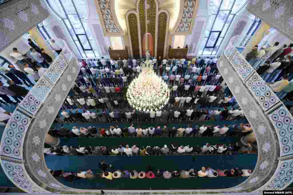 Muslim believers pray at a mosque near Pristina, Kosovo, on July 20.