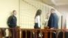 Yuri Dorn in a court cage as his trial gets under way in Minsk. 