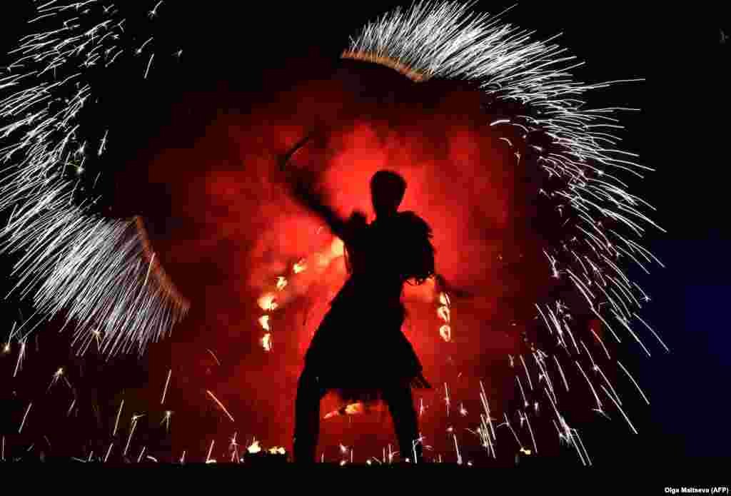 An actor performs a fire show in downtown St. Petersburg, Russia. (AFP/Olga Maltseva)