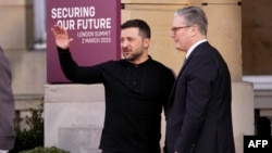 British Prime Minister Keir Starmer (right) greets Ukrainian President Volodymyr Zelenskyy as he arrives at a summit held at Lancaster House in central London on March 2.