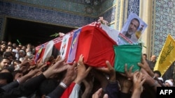 People carry the coffin of Mohammad Jamali Paqale, an officer of the Revolutionary Guards reportedly killed in fighting in the Syrian capital Damascus, during his funeral in the southern city of Kerman in November 2013.