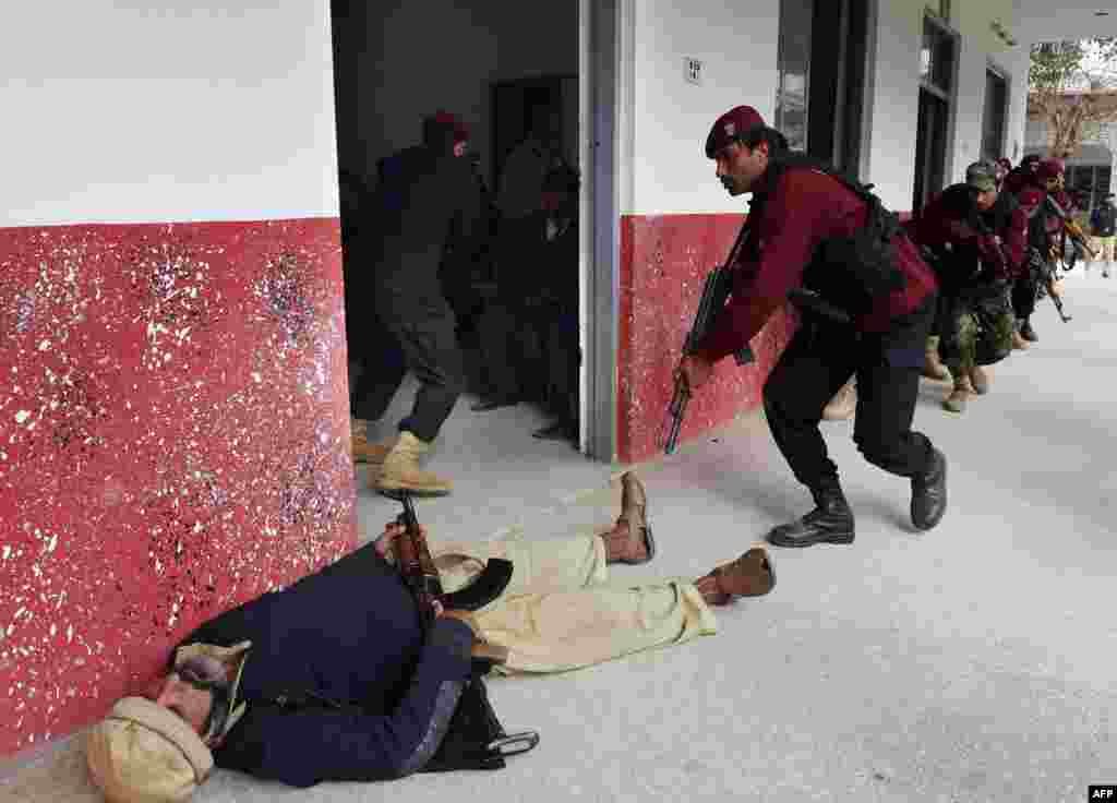 Members of Pakistan&#39;s Elite Police Force take part in a drill to fight against militants at a school in Peshawar on January 28. &nbsp;(AFP/A. Majeed)